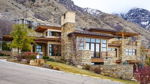 Modern single-family homes for sale in Utah with mountain views and suburban neighborhood streets.