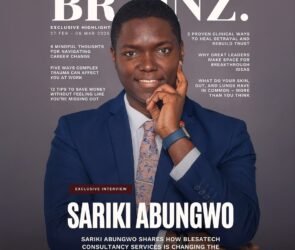 Professional reading Brainz Magazine articles on a laptop while working in a modern office