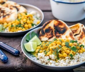 Camping dinner ideas including foil packet meals, burgers, chili, tacos, and Dutch oven cooking around a campfire.