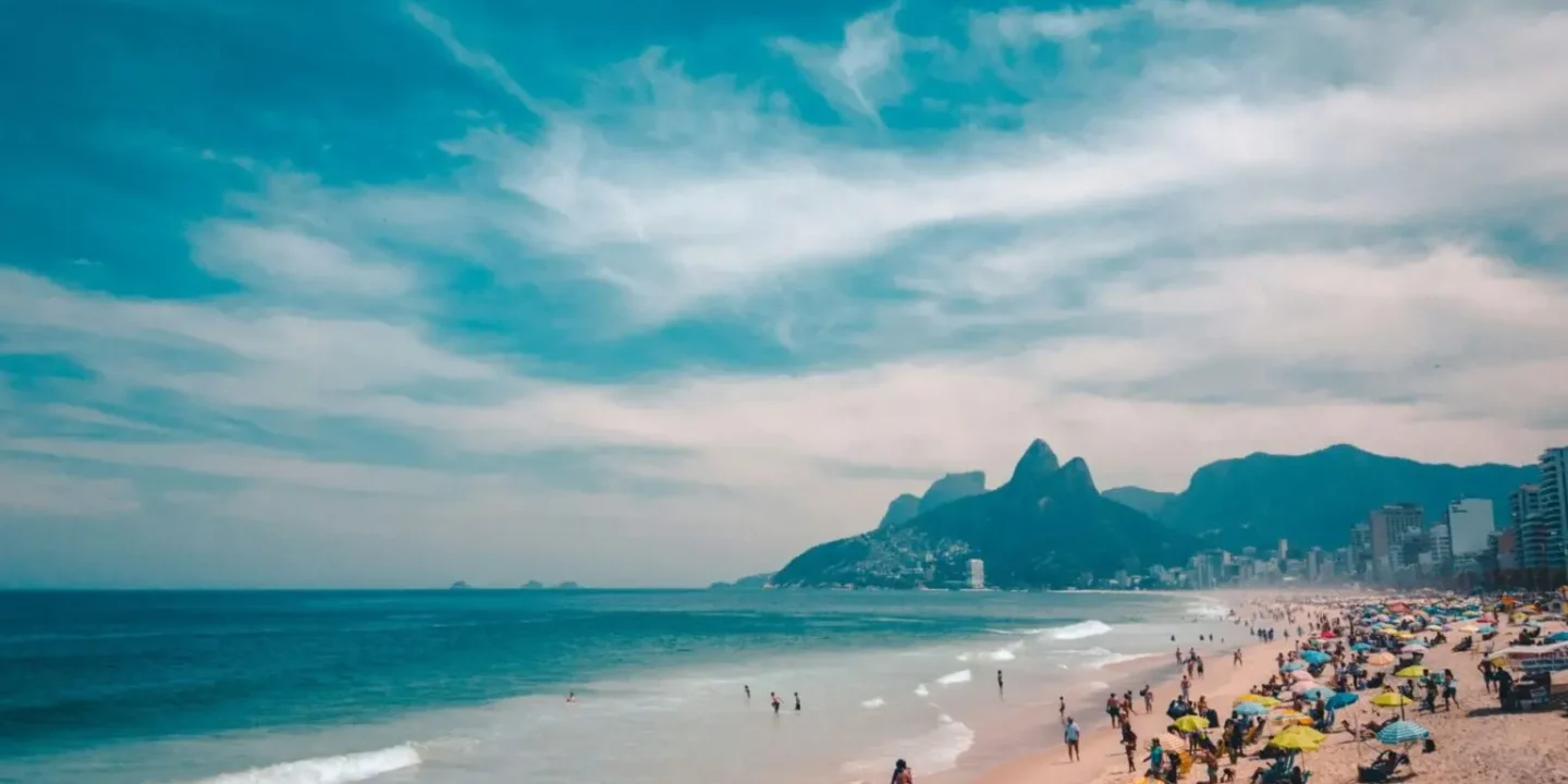 People enjoying Sundays in Rio with families relaxing on Ipanema Beach, cyclists along the waterfront, and a vibrant local market in Rio de Janeiro.