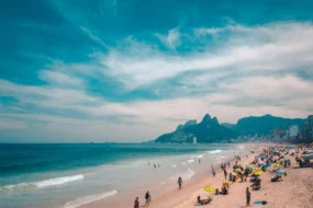 People enjoying Sundays in Rio with families relaxing on Ipanema Beach, cyclists along the waterfront, and a vibrant local market in Rio de Janeiro.