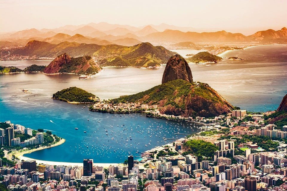 People enjoying Sundays in Rio with families relaxing on Ipanema Beach, cyclists along the waterfront, and a vibrant local market in Rio de Janeiro.