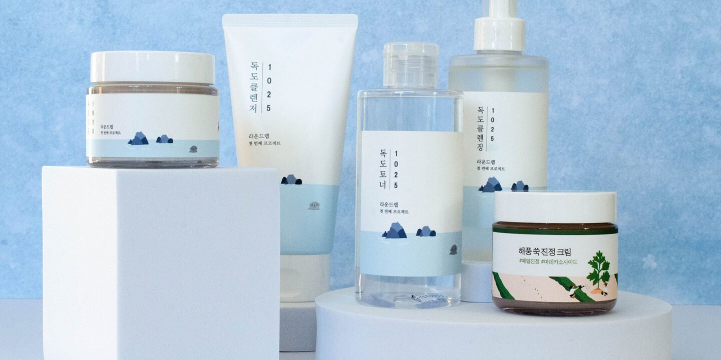 Round Lab Korean skincare products including Dokdo Toner, Birch Juice Moisturizing Cream, cleanser, and sunscreen arranged on a clean white background