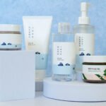 Round Lab Korean skincare products including Dokdo Toner, Birch Juice Moisturizing Cream, cleanser, and sunscreen arranged on a clean white background