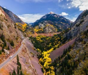 Panoramic view of Colorado's Million Dollar Highway winding through the San Juan Mountains near Red Mountain Pass